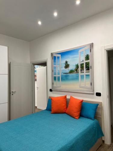 a bedroom with a bed with orange and blue pillows at Il villino di nonna Domenica in Lecce
