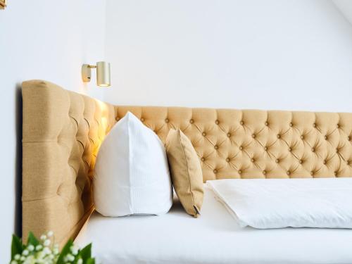 a bed with pillows on top of it at Hotel Lindenufer in Berlin