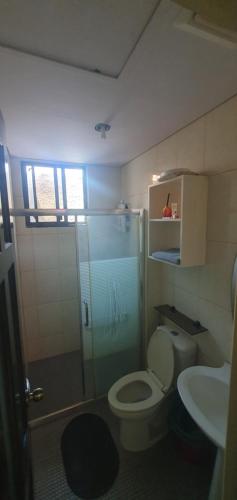 a bathroom with a shower and a toilet and a sink at Korean Town Pool Villa 2 in Angeles