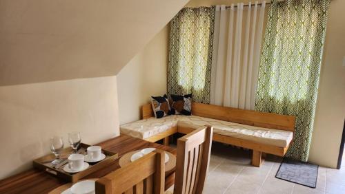 a living room with a table and a couch and a dining room at Unit 1O1 Nottingham Villas in Puerto Princesa City