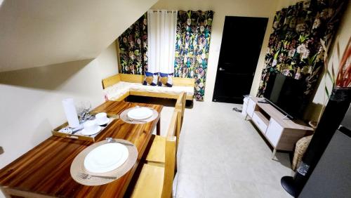 a small room with two tables and a fireplace at Unit 1O1 Nottingham Villas in Puerto Princesa City