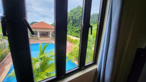 a view of a swimming pool from a window at Unit 1O1 Nottingham Villas in Puerto Princesa City