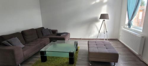 a living room with a couch and a coffee table at Ap 10 - 2 SZ bei Helmstedt und Oschersleben in Ausleben