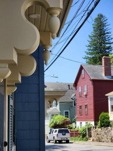 a white car parked on a street next to houses at Sailors Retreat in Marblehead