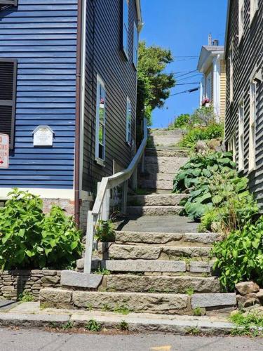 a set of stairs in front of a blue house at Sailors Retreat in Marblehead