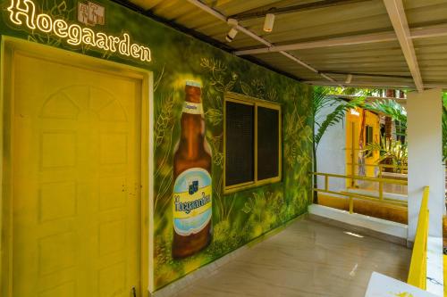 a building with a bottle of beer painted on the wall at Whoopers Party Hostel, Palolem in Palolem