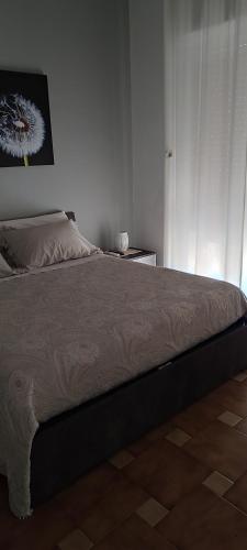a bedroom with a large bed with a picture on the wall at Giardino Massari in Lecce