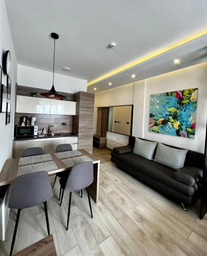a living room with a dining table and a couch at Vista Kopaonik Milmari Studio P22 in Kopaonik