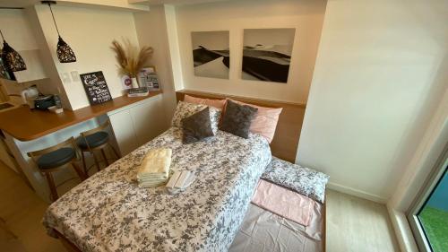 a small room with a bed and a bar at LeisureStay Studio @ Azure North in San Fernando