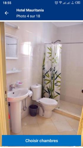 a bathroom with a toilet sink and a shower curtain at شقة مفروشة in Temara