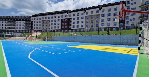 a basketball court in front of a building at Vista Kopaonik Milmari Studio P22 in Kopaonik