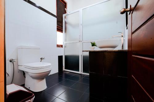 a bathroom with a toilet and a sink at Safari Lodge Yala in Kataragama