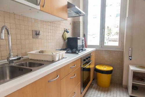 a small kitchen with a sink and a stove at Here's a new Laura's place - close to San Pietro in Rome