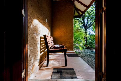 a chair sitting on the porch of a house at Safari Lodge Yala in Kataragama