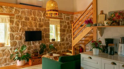a living room with a stone wall at Masal Evimiz in Antalya