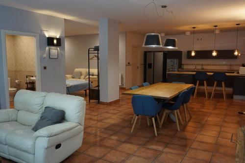 a living room and kitchen with a couch and a table at Bakio Beach House in Bakio