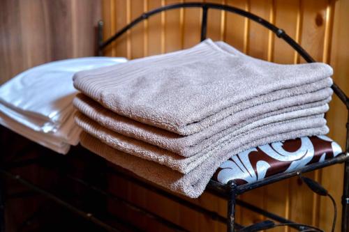 a pile of towels sitting on a rack at Вілія in Lomacineţi