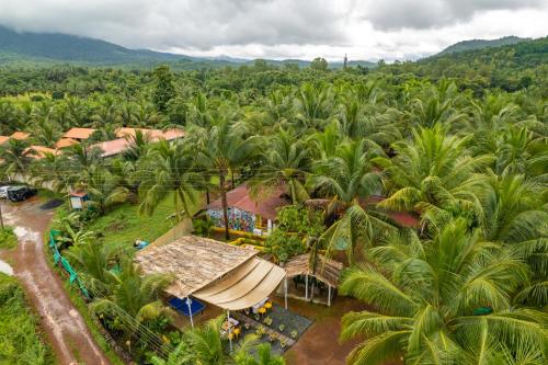 an aerial view of a resort with palm trees at Whoopers Party Hostel, Palolem in Canacona