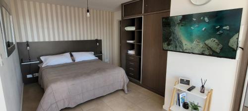 a bedroom with a bed and an aquarium on the wall at La Perla I in Mar del Plata