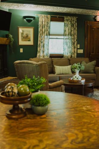 a living room with a table and a couch at Landoll's Mohican Castle in Loudonville