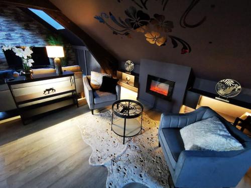 a living room with a blue couch and a fireplace at Cosy Loft near Geneva with Wi-Fi and Netflix in Ornex