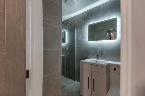 a bathroom with a sink and a shower at Cardiff Luxe Living Apartments in Cardiff