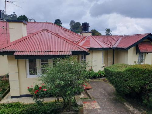 a house with red roofing on top of it at Ruchi House in Nuwara Eliya