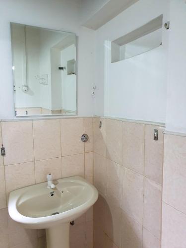a bathroom with a sink and a mirror at Ruchi House in Nuwara Eliya