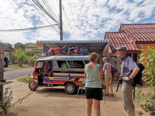 a group of people standing outside of a food truck at Khamphouy Guesthouse in Champasak