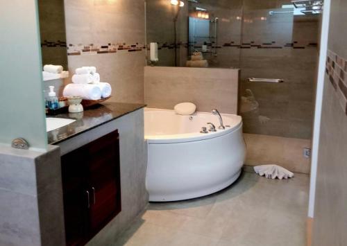 a bathroom with a large tub and a sink at IslandView Villa in Choeng Mon Beach