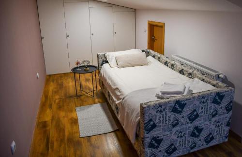 a bedroom with a bed and a table and cabinets at Studio apartment OAZA in Sisak