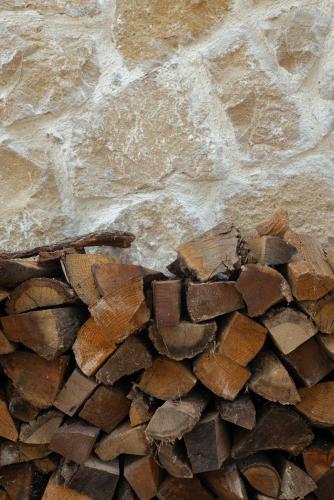 a pile of wood on a stone wall at Masal Evimiz in Antalya