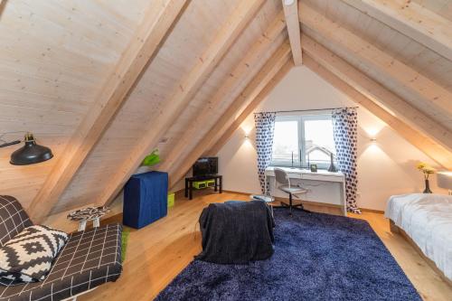 a room with a couch and a desk in a attic at BCA Family Villa ERH in Oberreichenbach
