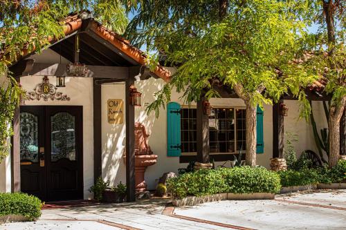 a house with a front door and trees at Old Ranch Inn - Adults Only 21 & Up in Palm Springs