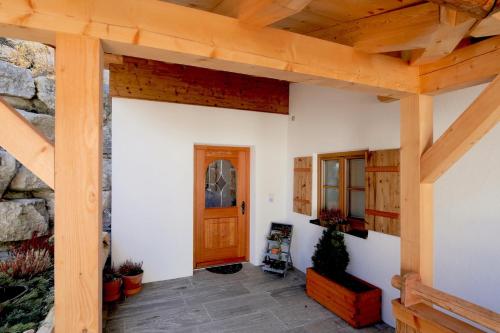 a room with a wooden door and a stone wall at Haus Kogelleiten in Ramsau