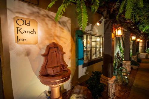 an old raval inn sign next to a toilet against a wall at Old Ranch Inn - Adults Only 21 & Up in Palm Springs