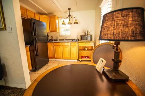 a kitchen with a table with a lamp on it at Old Ranch Inn - Adults Only 21 & Up in Palm Springs