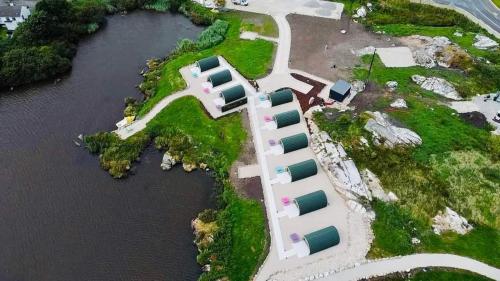 an aerial view of a house on an island in the water at Wheelhousepods glamping in Donegal