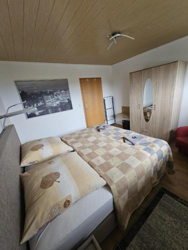 a bedroom with a bed with a checkered blanket at Ferienwohnung Talblick in Weimar