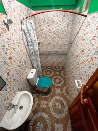 a small bathroom with a toilet and a sink at Hostal Sol y Lago in Copacabana