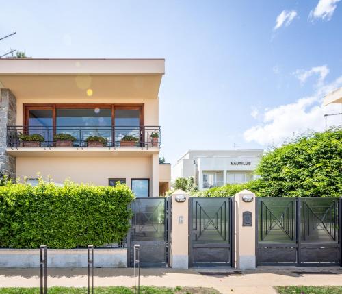 a house with black gates and a fence at In riva al mare in Cagliari