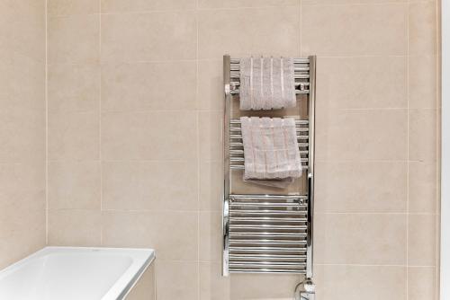 a bathroom with a towel rack with towels at Modern Luxe Living in Lincoln - Flat 8 in Lincolnshire