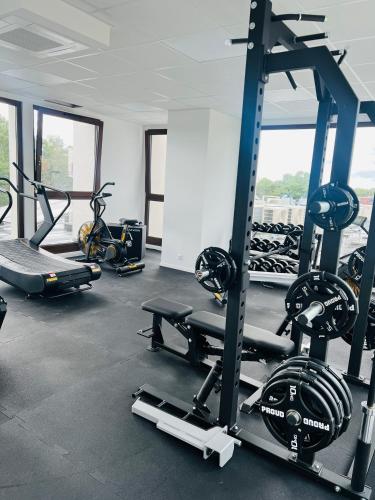 a gym with several tread machines in a room at Apartamenty Belni Hel Edyta i Maciej Wolak in Hel