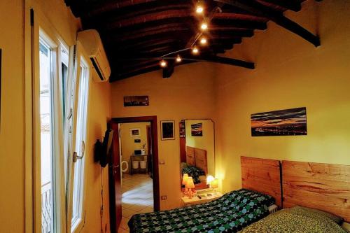 a bedroom with a bed and a large window at Apt bright, quiet! In the center. in Florence