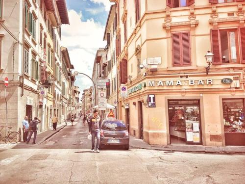 a man standing on a city street with a car at Apt bright, quiet! In the center. in Florence