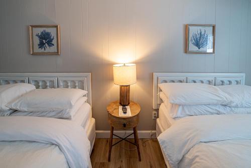 a room with two beds and a table with a lamp at Star Gate Motel in Indian River
