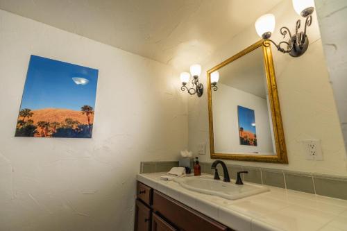 a bathroom with a sink and a mirror at Old Ranch Inn - Adults Only 21 & Up in Palm Springs