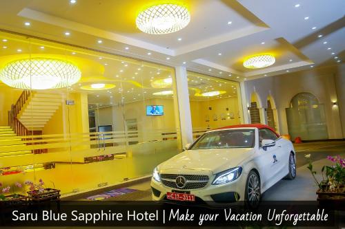 a car parked in a room with a hotel at Saru Blue Sapphire Hotel in Godakewela