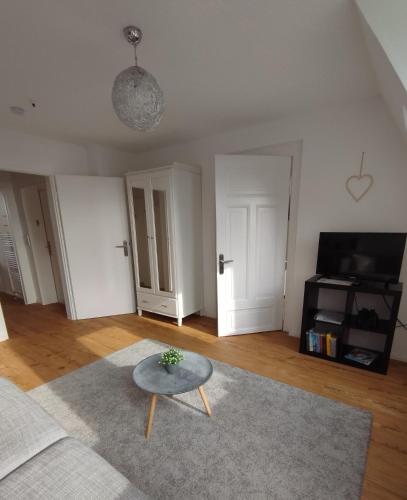 a living room with a couch and a table at Apartment am Yachthafen in Kiel