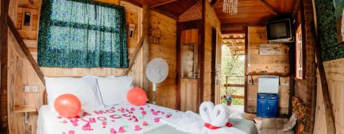a bedroom with a bed with red balloons on it at Pousada Kafofinho da Serra in Serra do Cipo